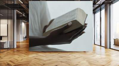 Photo of two hands praying with a bible in a church for faith, spirituality and religion. A woman does not remember ever holding a bible in her hands and praying. Wall mural