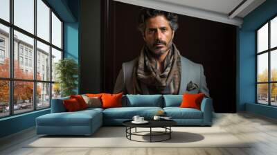 Portrait of a handsome Indian man in a grey suit and scarf. Wall mural