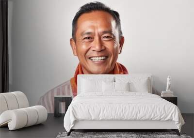 Portrait of a smiling asian man with a scarf on white background Wall mural