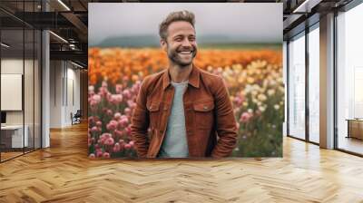 Portrait of a young handsome man in a field of poppies Wall mural