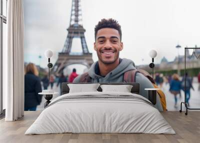 Portrait of happy young man with backpack in Paris, France. Wall mural