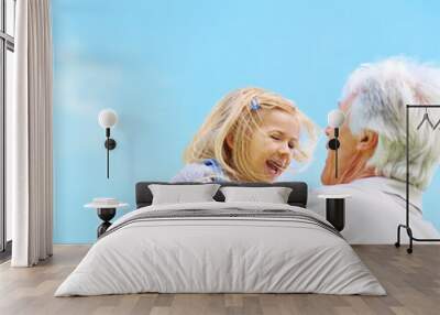 Granddad always knows how to make her laugh. Shot of a happy grandfather lifting his young granddaughter. Wall mural