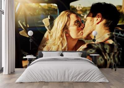 This road trip made us connect deeply with one another. Shot of an affectionate couple kissing in a pickup truck. Wall mural