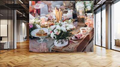 a bouquet of flowers on a table from pallets. celebrating with friends and family in a park or garden. outdoor picnic. festive boho wedding table Wall mural