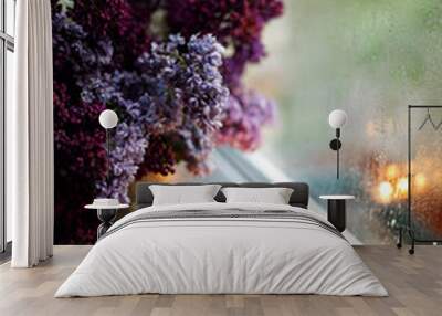 a cup of coffee by a rainy window near a bouquet of lilacs Wall mural