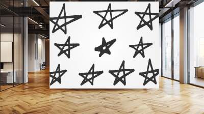 A set of distorted stars from the hand of a rough brush. Grunge sketch. 10 isolated abstract elements. Wall mural