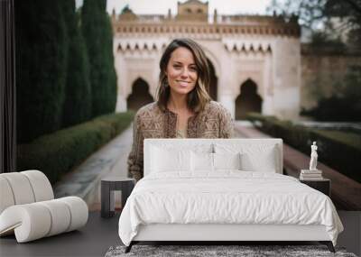 Portrait of a beautiful young woman in the courtyard of the Alhambra palace, Granada, Spain Wall mural