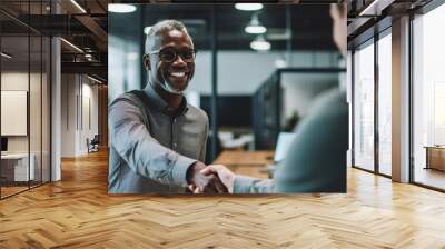 Business, career and placement concept successful young man smiling and handshaking with european businessman after successful negotiations or interview in office Wall mural