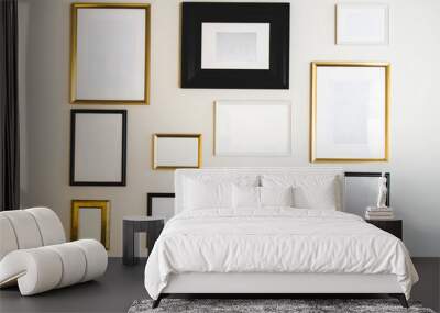 Empty gold and black photo and picture frames on white wall, mock up for your photos or text, copy space modern design luxury decoration Wall mural