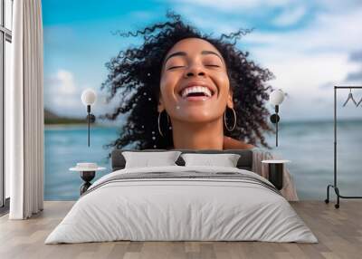 Happy smiling woman enjoying freedom and life at the beach.Happy cheerful smile of young female in sunlight having fun in the summer by the sea Wall mural