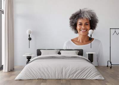 Portrait of smiling proud handsome african american senior woman standing against isolated white background. Wearing a white t-shirt copy space for advertisement or logo Wall mural