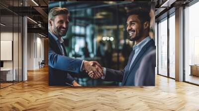 Two happy mature business men shaking hands in office. Successful african american businessman in formal clothing closing deal with handshake. Multiethnic businessmen shaking hands during a meeting. Wall mural