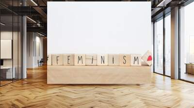 Wooden cubes with a hashtag and the word Feminism near white background, social media concept Wall mural