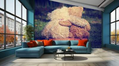 two teddy bears on a bench with arms around each other Wall mural