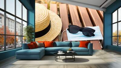 Safe Summer vacation. Sunglasses, mask and hat. Rest in the park Wall mural