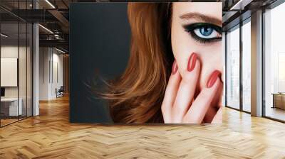 Beauty model with red hair with blue eyes and nails of trendy living coral color Wall mural