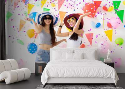 celebration new year or birthday party group of asian young woman and confetti happy,funny concept.drinking wine happy and fun in new year celebrate, color balloon  background. Wall mural