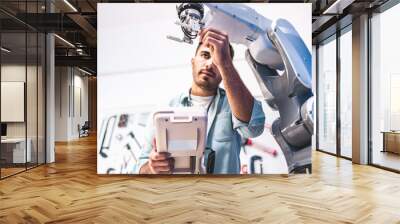 Male Engineers Maintenance Robot Arm at Lab. he are in a High Tech Research Laboratory with Modern Equipment. Technology and Innovation Concept.Professional Japanese Development Engineer is Testing . Wall mural