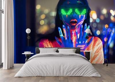 Neon  asian woman dancing. Fashion model woman in neon light, portrait of beautiful model with fluorescent make-up, Art and future design of female disco dancer posing in UV, colorful make up. Wall mural