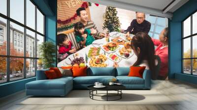 Thanksgiving or christmas Celebration Asian  Family Dinner Concept.family having holiday dinner.Happy family cooking for party. father mother and daughter, having dinner at home. Wall mural