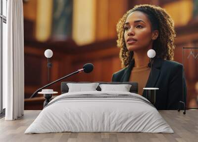 A professional female attorney stands in front of the courtroom, speaking into a microphone as she presents her case Wall mural