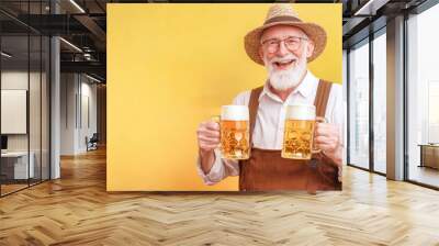 A cheerful senior man proudly holds two beer mugs, dressed in traditional lederhosen, embodying the festive spirit common during Oktoberfest celebrations Wall mural