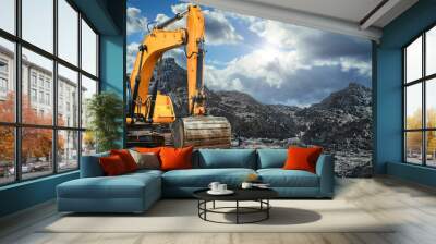 A large yellow excavator moving stone or soil in a quarry. Heavy construction hydraulic equipment. Excavation. Wall mural