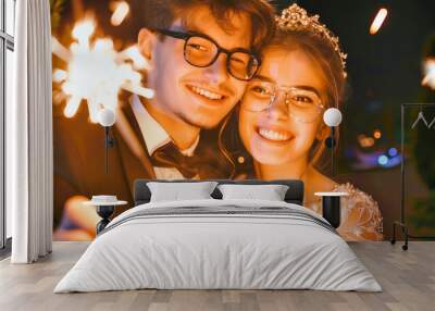 A young couple smiles brightly as they hold sparklers, celebrating a festive occasion with a romantic toast Wall mural