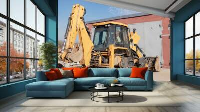 Repair of a broken excavator. Excavator without a wheel. Breakdown of a construction loader during operation. Wall mural