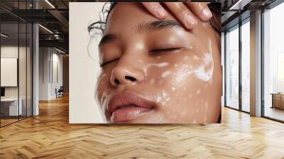 Close-up of a woman with a facial cleanser applied, highlighting skincare routine. Wall mural