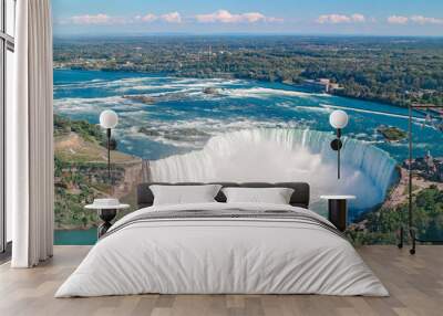 Aerial top landscape view of Niagara Falls  between United States of America and Canada. Horseshoe of Canadian waterfall on sunny day. Water tour boat at famous tourist landmark Wall mural