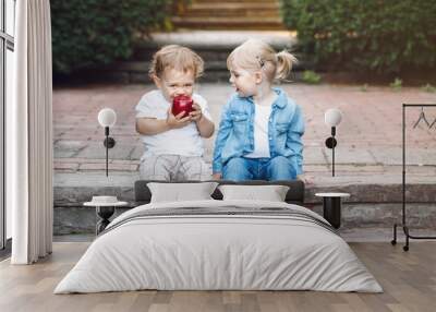 group portrait of two white caucasian cute adorable funny children toddlers sitting together sharing Wall mural