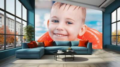 Portrait of white Caucasian child in swimming pool. Preschool boy  training to float with red circle ring in water. Web banner header for website. Healthy active lifestyle Wall mural