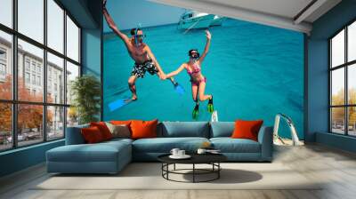 Happy young couple having snorkeling and beach fun on the yacht vacation honeymoon travel holidays. Caucasian woman and man playing playful enjoying love. Multiracial couple Wall mural