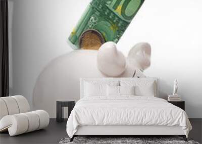 One hundred euro banknote and two euro coin insert into white porcelain pig, isolated on white background Wall mural