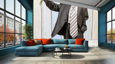 The young boy in a stylish suit with roses Wall mural