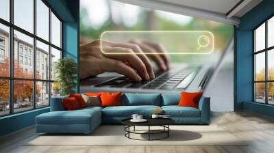 People hand using laptop or computor searching for information in internet online society web with search box icon. Wall mural