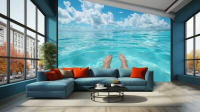 Woman's feet floating in turquoise ocean water tropical island background. Wall mural