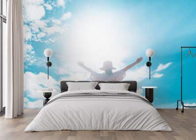 Woman rise hand up to amazing blue sky feel never give up and freedom. Wall mural