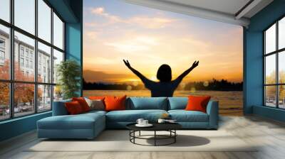 Woman rise hands up to sky freedom concept with blue sky. Wall mural