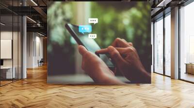 Women hand using smartphone typing, chatting conversation in chat box icons pop up. Social media maketing concept. Wall mural