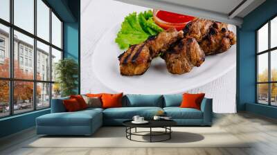 Grilled lamb chops served on white plate with spicy tomato sauce and salad Wall mural