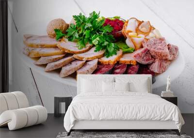 White plate presenting variety of delicious meat products on wooden table Wall mural