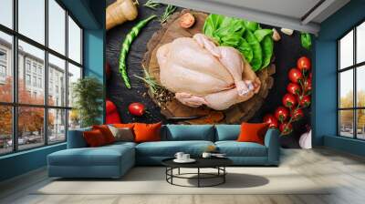 Whole raw chicken on a wooden board with spices for cooking, top view Wall mural