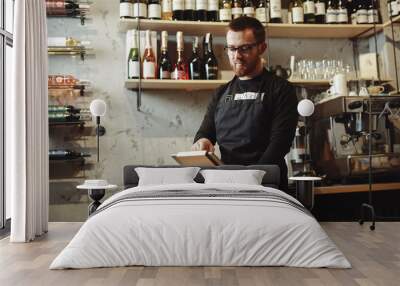 Barista working at the bar with tablet PC Wall mural