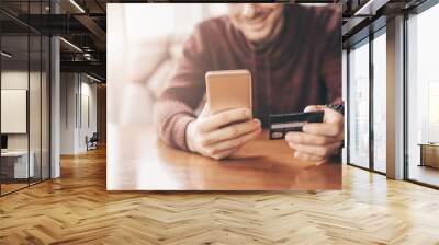 Online banking with smart phone, man rewrite a number of credit card Wall mural