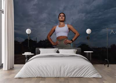 Sport woman portrait at the overcast cloudy day dramatic view Wall mural