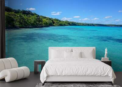 Lifou's bright blue waters along the treeline Wall mural