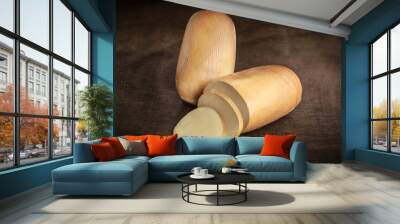 Provolone cheese with cut slices on top of beautiful wood Wall mural