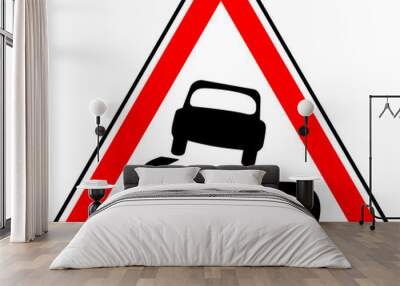 Vector graphic of a uk slippery surface road sign. It consists of a depiction of a car and curved skid marks contained within a red triangle Wall mural